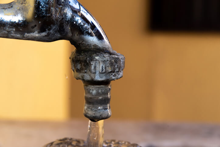 hard water deposits on sink faucet fixture