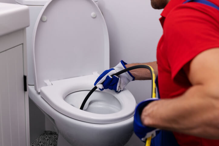 plumber working on toilet